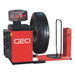 A red and black Geo tyre balancer with a commercial vehicle tyre mounted on a spindle, shown against a plain white background.