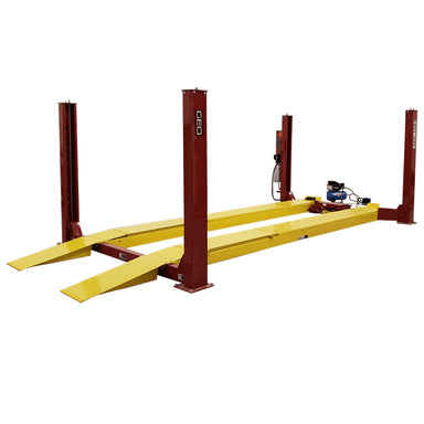 Yellow and red GEO 4 Post wheel alignment lift on a white background, side front view