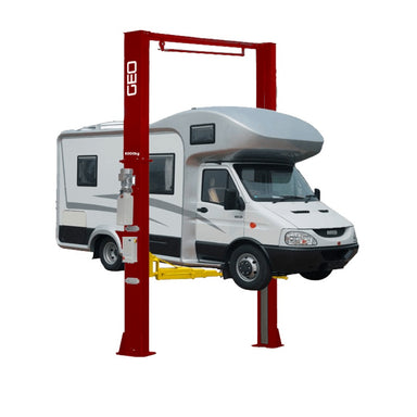Recreational vehicle on a yellow and red 2 Post 6 ton GEO C6000ES lift, front side view