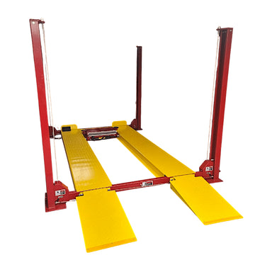 Red and yellow 4 post parking lift lowered to the ground on a white background, side front view