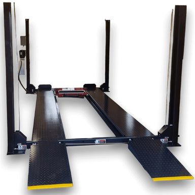 Dark blue four post vehicle storage lift with yellow ramp tips on a lowered position on a white background