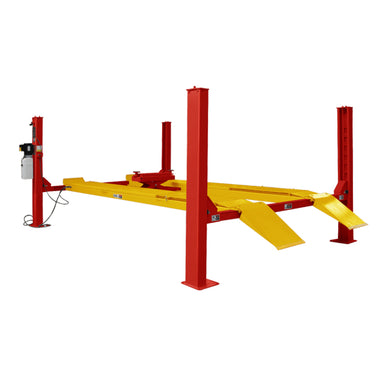 Red and yellow blue four post vehicle parking lift lift with the platform lowered halfway on a white background