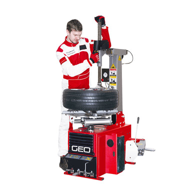 Person using a red GEO tire changer machine on a white background