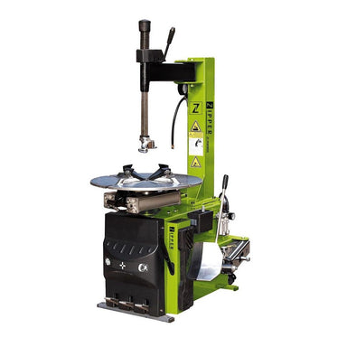 A green and black Zipper tyre changer  machine with a vertical press arm, circular tire platform, and side adjustment levers, shown on a plain white background. Front side view